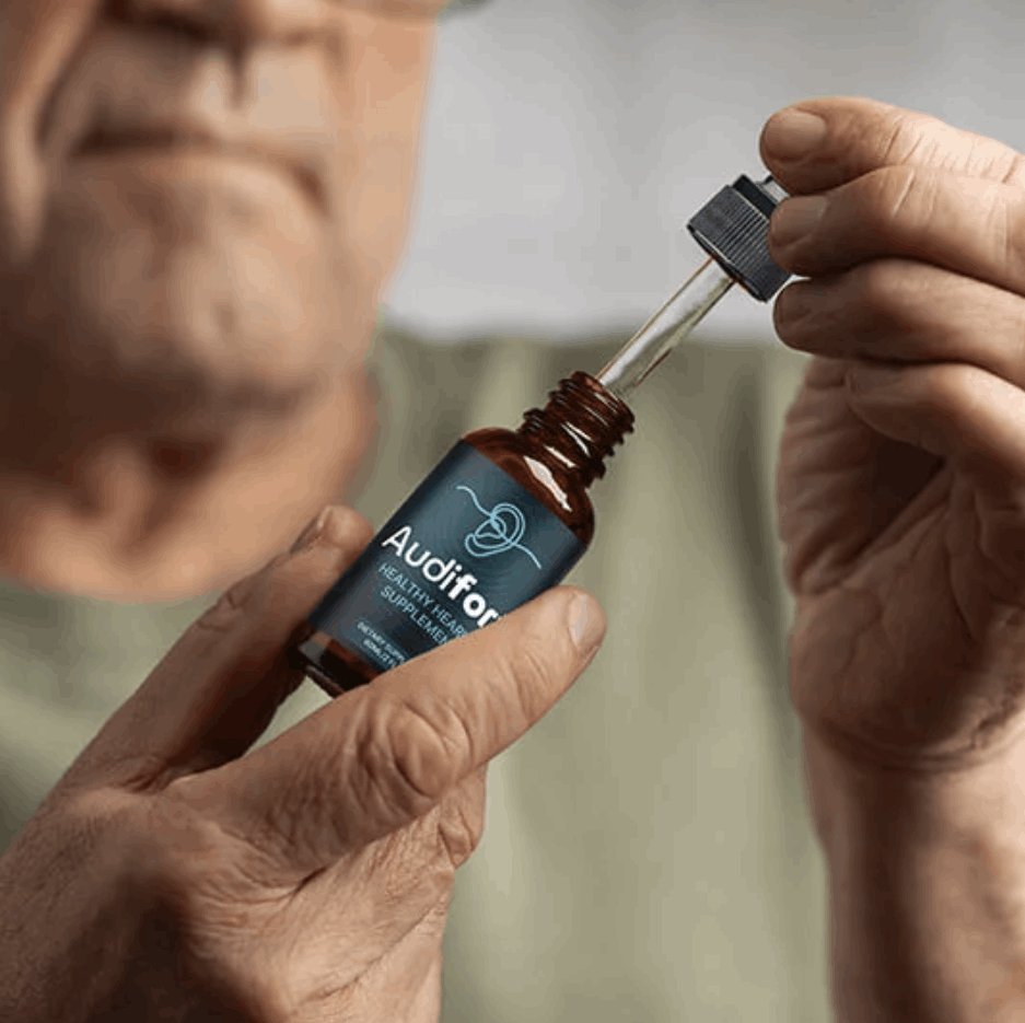 Close-up of an elderly man holding an Audifort Healthy Hearing Supplement bottle and using the dropper.